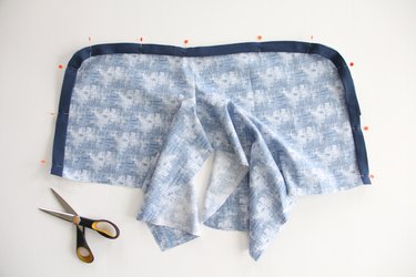 Sew bias tape to curved leg seams