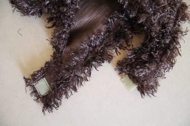 Tighten the hood by attaching a longer piece of hook-and-loop tape.