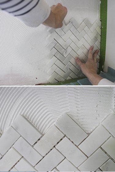 Pushing tile into mastic.