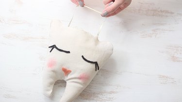 Gluing hanging ribbon inside pillow