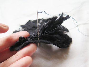 Using an overcast stitch to sewing the lace and wire together.