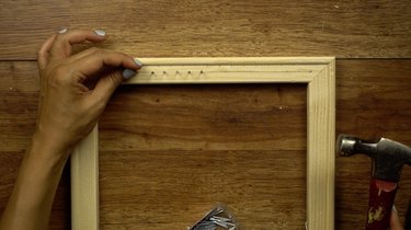 Hammering wire nails to make DIY simple frame loom.
