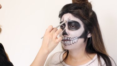 Highlight forehead and cheeks with white.