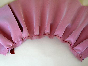 The entire waist line pinned with pleats.