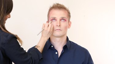Apply red shadow to lower eyelid
