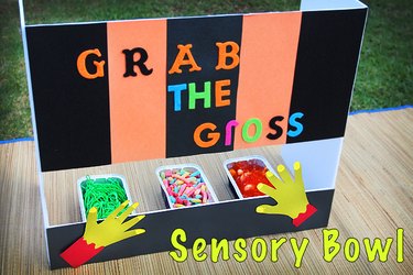 sensory bowls filled with candy hidden behind a panel