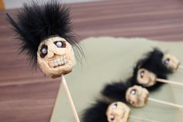 Dried-apple shrunken heads on skewers