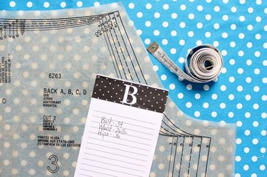Take your body measurements to determine which size to cut out.