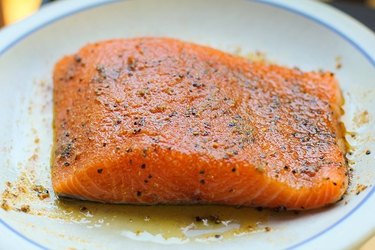 salmon on a plate with olive oil and spice rub