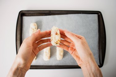 Hands shaping the croquettes.