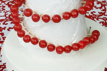 Place red candies in spiral around cone.