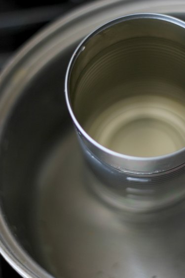 Fill a pot with an inch of water and insert clean can into pot