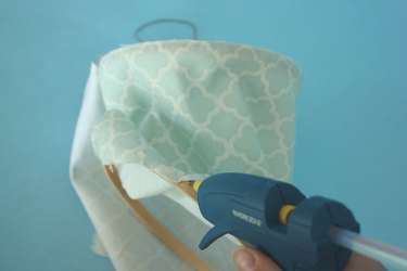 Glue the fabric to the bottom embroidery hoop.
