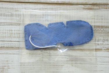 "DAD" design felt car air freshener with elastic loop tie, inside of cellophane party bag or pouch, with one end folded over and taped closed.