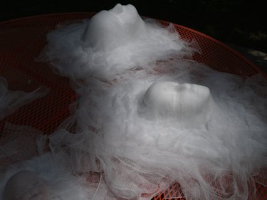 Cheesecloth heads drying outdoors.