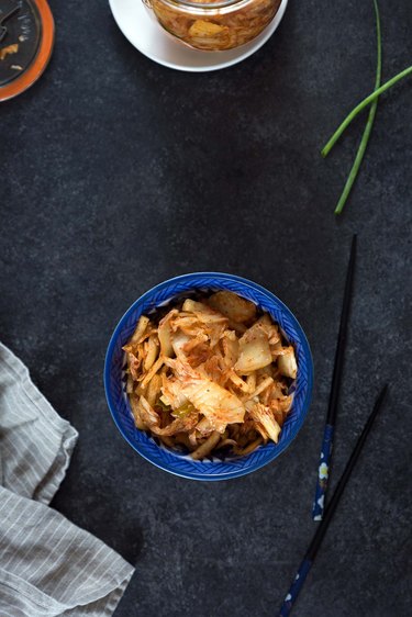 Homemade kimchi in a blue bowl