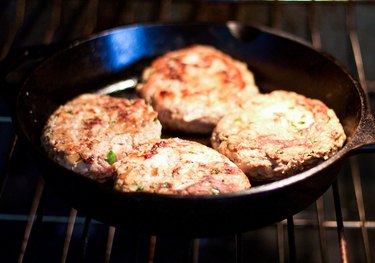 Baking the Turkey Burgers until they are cooked through.