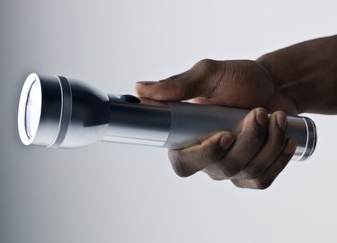 Hand holding a flashlight