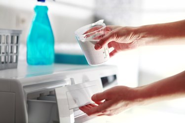 adding detergent to washing machine