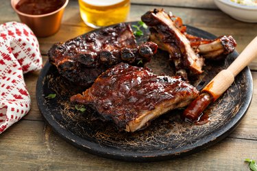 Grilled barbeque ribs with BBQ sauce and sides