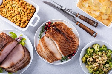 Roasted turkey breast thinly sliced for dinner with spiral cut ham and all the side dishes