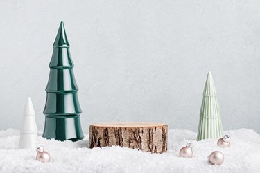 Christmas holiday wooden podium or stand in snow with ceramic Christmas trees