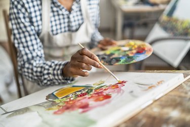Female artist working with paints