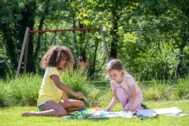 Girls drawing in garden