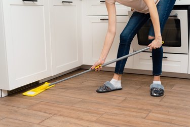 Washing dust and dirt from under the kitchen cabinet