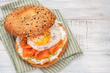 Bagel sandwich with salmon, cream cheese, avocado and egg.
