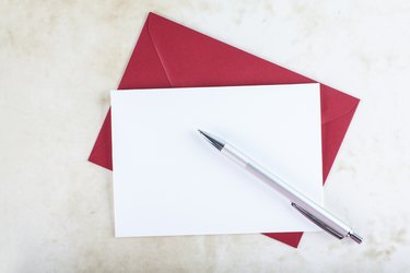 Red envelope, blank invitation cart and pen.