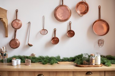 Set of saucepans hanging on wall