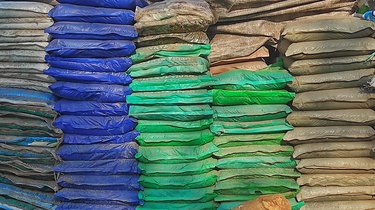 a stack of dusty sack which contains fertilizer in florist