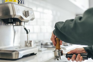 Woman making coffee at home