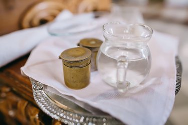 Baptism holy water container. Jug with holy water.