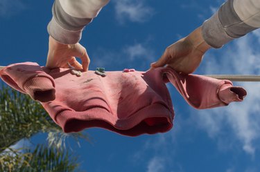 Pink diver with stains that do not come out hanging on the rope