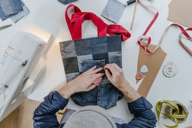 Fashion designer stitching pocket on shopping bag