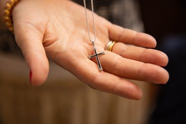 Orthodox christenings of a child, a cross in his father's hand
