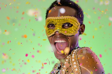 Throwing confetti in brazil party Carnival. black man dressed up for the Party and celebration