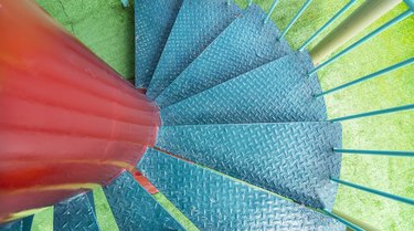 Old grungy wooden colorful spiral staircase exterior