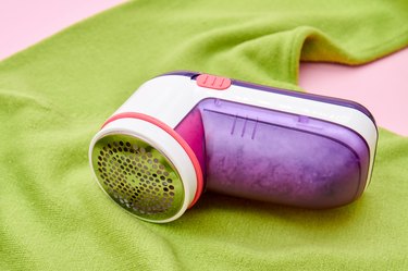 Fabric shaver on green sweater