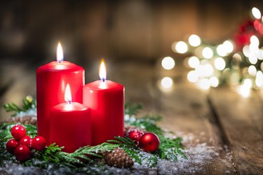 Christmas candles on rustic wooden table. Copy space