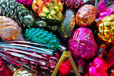 New Year and Christmas tree decorations, glass balls in the form of cones and baskets. Cones and pendants made of shiny tinsel.