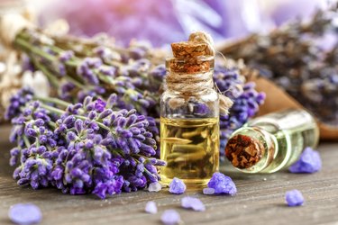 lavender's spa products with dried lavender flowers on a wooden table. Flat lay bath salt and massage oil on wooden background. Skin care, beauty treatment concept. Lavendula oleum
