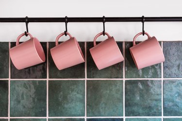 Metal hanging rack with mugs in kitchen