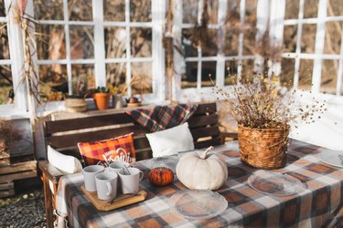 Hygge home terrace with decorated table for tea time.