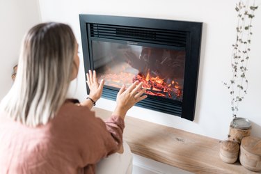 woman heating the house. concept of energy crisis