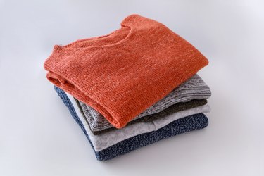 High Angle View Of Sweaters Against White Background