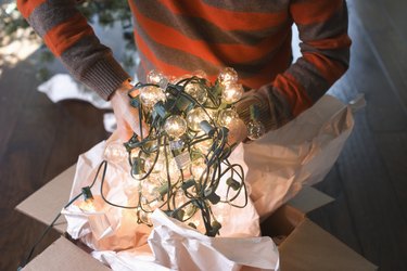 Man Holding Tangled String of Christmas Lights
