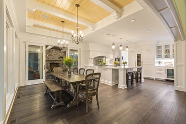 Dining area with yellow wood paneled ceiling and white beams